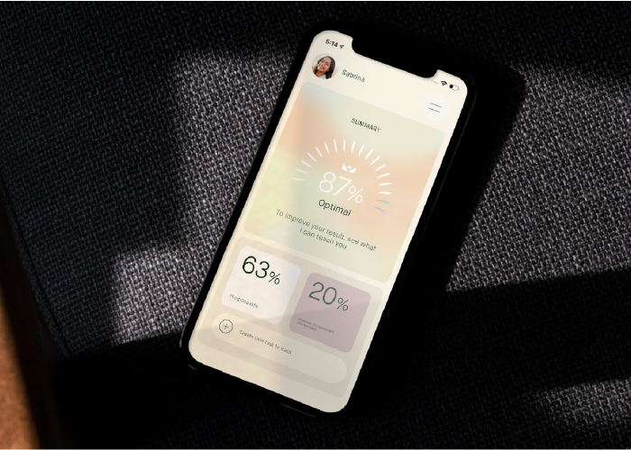 smartfon z aplikacją wellbri leżący na czarnym tle